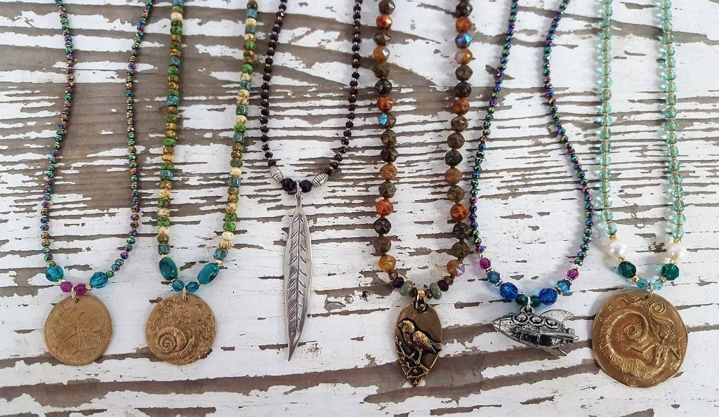 Liz Bowens dichroic glass and metal jewelry is featured in her new show opening Sept. 7, 2018, at the Art Shop Gallery, Homer, Alaska. (Photo provided)