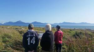 Participants in a pre-performance silent estuary walk contemplate Wendy Erds poetry on Sept. 2, 2018 at the Beluga Slough in Homer, Alaska. (Photo by Mira Klein)