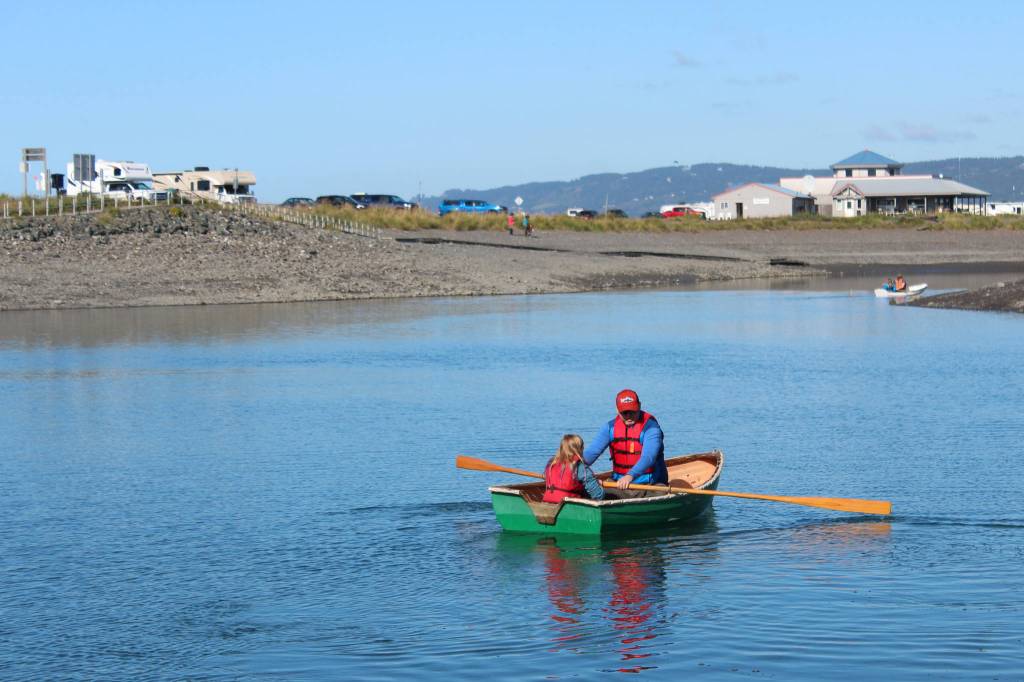 A man rows a young girl around the Nick Dudiak Fishing Lagoon in a wooden boat Saturday, Sept. 1, 2018 during the Kachemak Bay Wooden Boat Festival on the Homer Spit in Homer, Alaska. (Photo by Megan Pacer/Homer News)