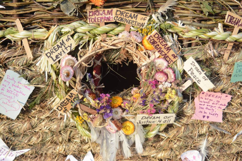 Signs and other objects adorn the 2018 Burning Basket, Dream, on Sept. 9, 2018 at Mariner Park in Homer, Alaska. (Photo by Michael Armstrong/Homer News)