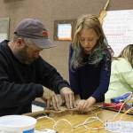 Reilly Sue Baker, 9, makes a violin out of cardboard with the help of her dad, Bryan Baker, on Thursday, Sept. 6, 2018 at Paul Banks Elementary School in Homer, Alaska. The violin-making project is part of the schools Preludes Violin Program, which puts real violins in the hands of elementary students after months of learning learning the necessary skills to handle one. The music instruction is used to enhance their learning experience. (Photo by Megan Pacer/Homer News)