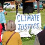 Area residents listen to Lydia Olympic, who worked with The Wilderness Society as a tribal advocate, as she gives a short speech Saturday, Sept. 8, 2018 at the Rise for Climate, Jobs and Justice rally and march at WKFL Park in Homer, Alaska. The local event, which ended in a march down to Mariner Park, was part of a larger movement of rallies held nationally on Sept. 8. (Photo by Megan Pacer/Homer News)