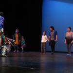 Larry Yazzi, founder of the Native Pride Dancers, teaches some dance moves to members of the audience Thursday, Sept. 6, 2018 in the Homer High School Mariner Theatre in Homer, Alaska. The dance group traveled from Minnesota to performs in several schools and venues on the Kenai Peninsula. Their visit was made possible by the Native Youth Community Project. (Photo by Megan Pacer/Homer News)