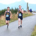 Homers Seth Inama (left) and Mose Hayes (right) approach the finish line of the boys 5K race together during the Homer Invitational for cross country Saturday, Sept. 7, 2018 on the Homer Spit in Homer, Alaska. (Photo by Megan Pacer/Homer News)