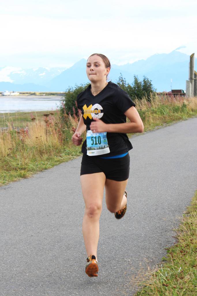 Faena Basargin, a Voznesenka senior, approaches the finish line of the 5K Homer Invitational on Friday, Sept. 7, 2018 on the Homer Spit in Homer, Alaska. Voznesenka had two runners at the event. (Photo by Megan Pacer/Homer News)