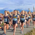 Athletes from Homer High School and Soldotna High School lead a pack of cross-country runners in the girls 5K race during the Homer Invitational on Friday, Sept. 7, 2018 on the Homer Spit in Homer, Alaska. The Soldotna girls team took first and Homer placed second by just one point. (Photo by Megan Pacer/Homer News)