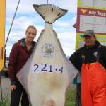 Ashley Camp from Vancouver, British Columbia, poses on July 29 with her 221.4 pound and 76-inch halibut caught while fishing with Midnight Sun Charters and Captain Brian Nollar on the Belle Ile. Camp is the 2018 winner of the Homer Jackpot Halibut Derby. (Photo provided)