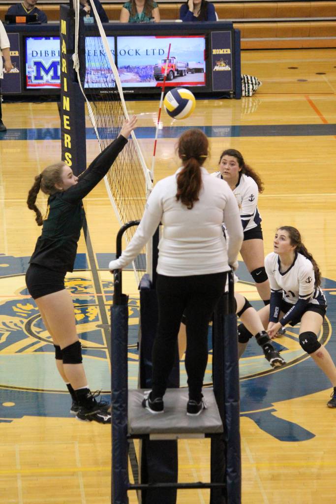 Sewards Sequioa Sieverts blocks the ball, sending it back over the net to the Mariners, during one of their games Saturday, Sept. 22, 2018 in the Alice Witte Gymnasium in Homer, Alaska. (Photo by Megan Pacer/Homer News)