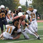 Homer senior Jadin Mann (66) plows through a group of Seward High School football players to score a touchdown during Homers homecoming game Friday, Sept. 21, 2018 at Homer High School in Homer, Alaska. (Photo by Megan Pacer/Homer News)