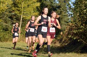 Kenai Centrals Jaycie Calvert leads Grace Christians Mazzy Jackson, and Kenai Centrals Brooke Satathite and Summer Foster, early in the Division II girls race at the Region 3 meet Saturday, Sept. 22, 2018, at Tsalteshi Trails. (Photo by Jeff Helminiak/Peninsula Clarion)