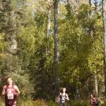 Grace Christians Gabe Martin leads Kenai Centrals Maison Dunham and the pack down a hill Saturday, Sept. 22, 2018, in the Division II race at the Region 3 meet at Tsalteshi Trails. (Photo by Jeff Helminiak/Peninsula Clarion)