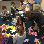 Homer High School senior Henry Russell works with Paul Banks Elementary School kindergarten students in Mrs. Wendy Todds classroom. (Photo by Wendy Todd)