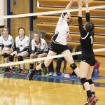 Homers Kelli Bishop spikes the ball over to players from Houston High School during their game Saturday, Sept. 29, 2018 in Homer, Alaska. (Photo by Megan Pacer/Homer News)