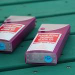 Two kits of the drug Naloxone, commonly called Narcan, rest on a picnic table before a Light the Night march Saturday, Sept. 29, 2018 at WKFL Park in Homer, Alaska. The kits are used to reverse the immediate effects of an overdose and can buy patients extra time to get to a hospital to be treated. (Photo by Megan Pacer/Homer News)