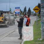 Nancy Lord, left, and Donna Aderhold, right, wave signs on Pioneer Avenue on election day, Tuesday, Oct. 2, 2018, in Homer, Alaska. Lord campaigned for her husband, Ken Castner, the apparent winner in the city of Homer mayoral race. Aderhold was the top vote-getter for the race for two Homer City Council seats. (Photo by Michael Armstrong/Homer News)