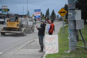Nancy Lord, left, and Donna Aderhold, right, wave signs on Pioneer Avenue on election day, Tuesday, Oct. 2, 2018, in Homer, Alaska. Lord campaigned for her husband, Ken Castner, the apparent winner in the city of Homer mayoral race. Aderhold was the top vote-getter for the race for two Homer City Council seats. (Photo by Michael Armstrong/Homer News)