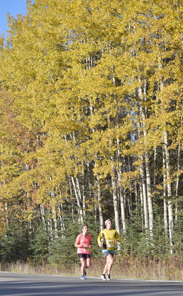 Nikiskis Frieda Tuttle leads Soldotnas Maria Dammeyer down Beaver Loop Road during the half marathon of the Kenai River Marathon on Sunday. Tuttle was the 18th woman across the finish line, while Dammeyer was 19th. (Photo by Jeff Helminiak/Peninsula Clarion)