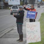 Nancy Lord, left, and Donna Aderhold, right, wave signs on Pioneer Avenue on election day, Tuesday, Oct. 2, 2018, in Homer, Alaska. Lord campaigned for her husband, Ken Castner, the apparent winner in the city of Homer mayoral race. Aderhold was the top vote-getter for the race for two Homer City Council seats. (Photo by Michael Armstrong/Homer News)