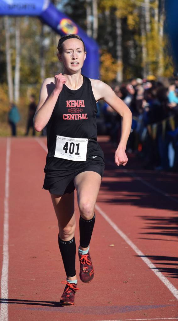 Kenai Central senior Jaycie Calvert sprints to the finish line to win the Division II girls state title Saturday at the ASAA state cross-country running championships at the Bartlett Trails in Anchorage. (Photo by Joey Klecka/Peninsula Clarion)