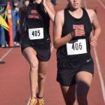 Kenai Central sister duo Brooke (left) and Logan Satathite sprint to the finish of the Division II girls race Saturday at the ASAA state cross-country running championships at the Bartlett Trails in Anchorage. (Photo by Joey Klecka/Peninsula Clarion)