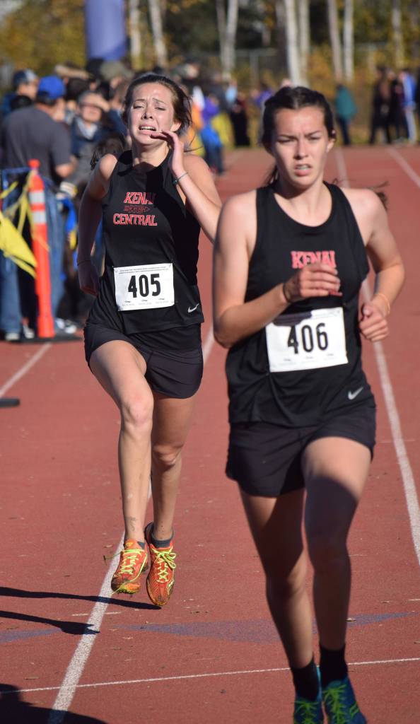 Kenai Central sister duo Brooke (left) and Logan Satathite sprint to the finish of the Division II girls race Saturday at the ASAA state cross-country running championships at the Bartlett Trails in Anchorage. (Photo by Joey Klecka/Peninsula Clarion)