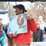 Fisheries biologist Martin Schuster holds up a diagram showing one of the stages of salmon fertilization and growth during an educational egg take trip for students from Chapman School and Fireweed Academy on Thursday, Oct. 4, 2018 at the Anchor River in Anchor Point, Alaska. (Photo by Megan Pacer/Homer News)