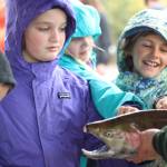 Students get an up close look at a salmon during an educational egg take trip to the Anchor River on Thursday, Oct. 4, 2018 in Anchor Point, Alaska. Eggs are harvested and fertilized, then sent back to each classroom so the students can watch them grow into fry. (Photo by Megan Pacer/Homer News)