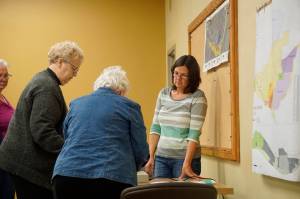 Homer City Clerk Melissa Jacobsen, right, watches as Election Canvass Board members Maryann Lyda, left, and Alice Krivitsky, center, feed ballots through an AccuVote machine during the Oct. 5, 2018, meeting of the canvass board in Homer, Alaska. The board counted the absentee and other ballots uncounted on Tuesdays election. The overall result did not change, with Ken Caster winning the election of Homer Mayor and Donna Aderhold and Heath Smith winning re-election to the Homer City Council. (Photo by Michael Armstrong/Homer News)