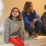 Thea James, Emma Macauly and Natalia Sherwood listen to information about a holding cell while they explore it at the Homer Courthouse on Oct. 8, 2018 in Homer, Alaska. The Fireweed Academy students and their classmates took a field trip to the courthouse to learn more about its inner workings and the law. (Photo by Megan Pacer/Homer News)