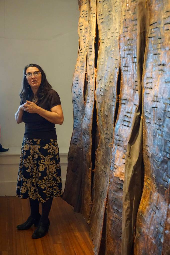 Keren Lowell speaks about her show at Bunnell Street Arts Center for its First Friday, Oct. 6, 2018, opening in Homer, Alaska. (Photo by Michael Armstrong/Homer News)