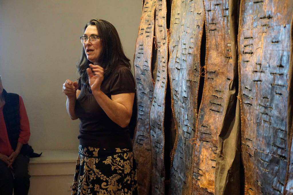Keren Lowell speaks about her show at Bunnell Street Arts Center for its First Friday, Oct. 6, 2018, opening in Homer, Alaska. (Photo by Michael Armstrong/Homer News)