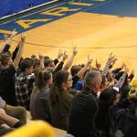 Spectators at the volleyball game between Homer High School and Nikiski on Saturday, Oct. 13, 2018 in Homer, Alaska, hold up one finger to signal that their team had one more point to go in order to win the set. Homer beat Nikiski three games to one. (Photo by Megan Pacer/Homer News)