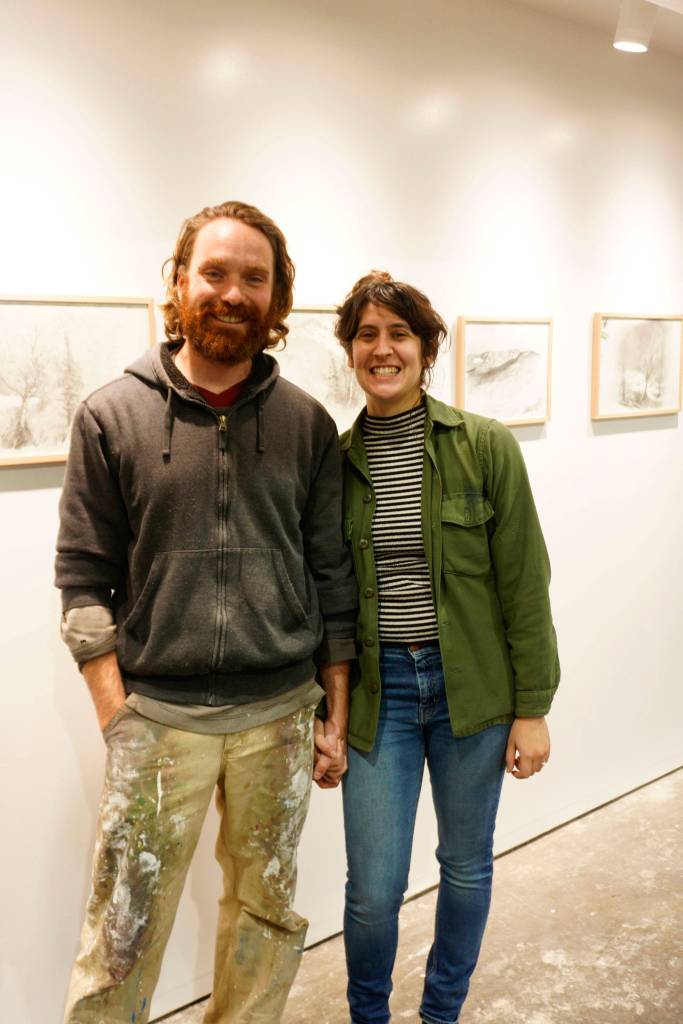 David and Elissa Pettibone pose on Tuesday, Oct. 16, 2018, by an exhibit of Karl Koetts work at The Shop, an art space the Pettibones started in August 2018 in Kachemak City, Alaska. The Shop includes gallery space, but provides studio and classroom space as its main focus. (Photo by Michael Armstrong/Homer News)