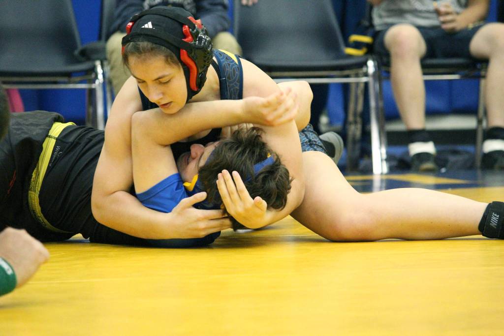 Homers McKenzie Cook works on pinning Kodiaks Terrance Schoenwether during a Friday, Oct. 19, 2018 dual match between their two schools at Homer High School in Homer, Alaska. Cook did eventually pin her opponent. (Photo by Megan Pacer/Homer News)