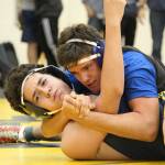 Kodiaks Josh Nummer holds Homers Cayleb Diaz in place during their 171-pound weight class wrestling match Friday, Oct. 19, 2018 at Homer High School in Homer, Alaska. (Photo by Megan Pacer/Homer News)