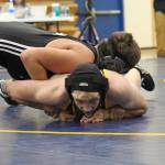 Antonin Murachev struggles to get out from under Nikiskis Simon Grenier during a dual meet Friday, Oct. 19, 2018 at Homer High School in Homer, Alaska. Grenier would go on to win the 152-pound weight class match. (Photo by Megan Pacer/Homer News)