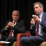 Democratic nominee for governor in Alaska, Mark Begich, speaks during a chamber of commerce gubernatorial candidate forum on Thursday, Sept. 6, 2018, in Juneau, Alaska, as Gov. Bill Walker, left, looks on. The forum featured the three major candidates in the race, including Republican nominee Mike Dunleavy, who is not pictured. (AP Photo/Becky Bohrer)