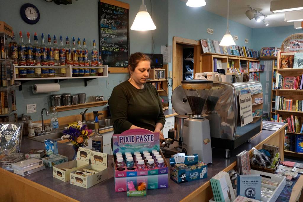 Jennifer Norton makes a latte at the Homer Bookstores coffee stand on Oct. 29, 2018, in Homer, Alaska. (Photo by Michael Armstrong/Homer News).