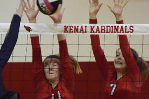 Kenai teammates Kailey Hamilton (11) and Lexi Reis (7) put up a block against Homers Karmyn Gallios, Friday night at Kenai Central High School. (Photo by Joey Klecka/Peninsula Clarion)