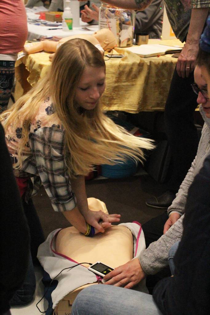 Maddox Berg, 14, practices performing CPR with the help of Homer Volunteer Fire Departments Donna McNulty during the annual Rotary Health Fair on Saturday, Nov. 3, 2018 at Homer High School in Homer, Alaska. (Photo by Megan Pacer/Homer News)