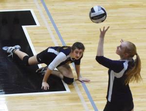 Homer sophomore Marina Carroll watches as teammate Kelli Bishop sends the ball into Nikiskis court Tuesday night at Nikiski High School. (Photo by Joey Klecka/Peninsula Clarion)