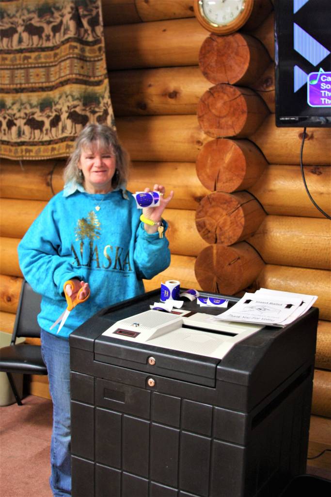 Election official Jolayne Soplanda mans the ballot box and rewards voters with I Voted stickers at the Anchor Point Senior Center during the midterm elections on Tuesday, Nov. 6, 2018, in Anchor Point, Alaska. (Photo by Delcenia Cosman)