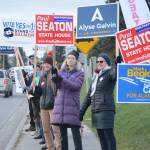 Democratic Party supporters wave signs in support of Paul Seaton, Mark Begich, Alyse Galvin and Yes on Ballot Measure 1. They were at the corner of Lake Street and Pioneer Avenue about 12:30 p.m. Nov. 6, 2018, in Homer, Alaska. (Photo by Michael Armstrong/Homer News0