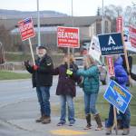 Rep. Paul Seaton, left, waves signs with other supports at the corner of Lake Street and East End Road on Nov. 6, 2018, in Homer, Alaska. (Photo by Michael Armstrong/Homer News)