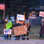 Democrats and Republicans share the sidewalk in front of WKFL Park on election day, Nov. 6, 2018, in Homer, Alaska. (Photo by Michael Armstrong/Homer News)