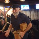 Rep. Paul Seaton hands out flashlights at an election night party at Alices Champagne Palace on Nov. 6, 2018, in Homer, Alaska. (Photo by Michael Armstrong/Homer News)