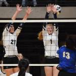 Homers Marina Carroll (21) and Kelli Bishop (1) team up for a block against the Barrow Whalers Friday, Nov. 9, 2018 at the Class 3A state volleyball tournament at the Alaska Airlines Center in Anchorage, Alaska. (Photo by Joey Klecka/Peninsula Clarion)