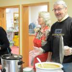 Dennis Weidler, coordinator of the Homer Community Food Pantry, right, serves soup at the Empty Bowls lunch Friday, Nov. 9, 2018, at Homer United Methodist Church in Homer, Alaska. Helping him are Deb Schmidt, center, and Karen Murdock, far left. More than 15 potters donated ceramic bowls for the annual fundraiser for the food pantry. (Photo by Michael Armstrong/Homer News)