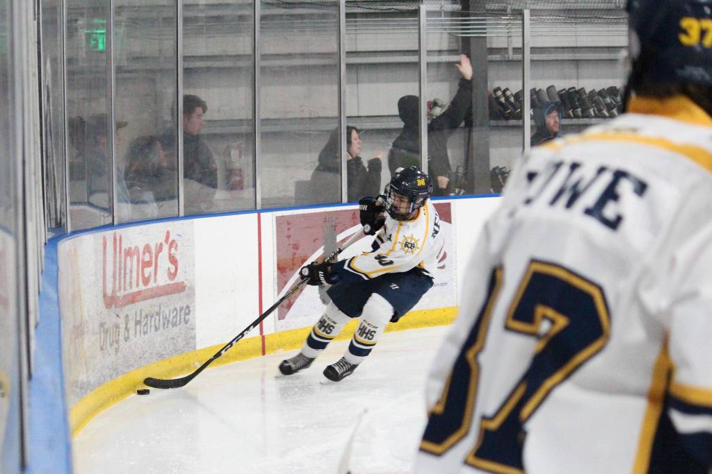 Homers Isaiah Nevak scoops the puck out of the corner during a game against Service High School on Thursday. Nov. 15, 2018 during the End of the Road Shootout at Kevin Bell Arena in Homer, Alaska. (Photo by Megan Pacer/Homer News)