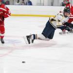 Homers Ethan Pitzman lands on the ice in a fight for the puck during a game against Wasilla High School on Saturday, Nov. 17, 2018 during the End of the Road Shootout at Kevin Bell Arena in Homer, Alaska. (Photo by Megan Pacer/Homer News)